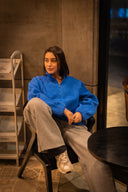 FUE Alpine Polar Fleece - woman in blue fleece jacket sitting on chair indoors
